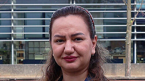 Rezvan Kakavand begins promotion A portrait of a woman outdoors in front of a modern university building. She is wearing a denim jacket and looking at the camera.